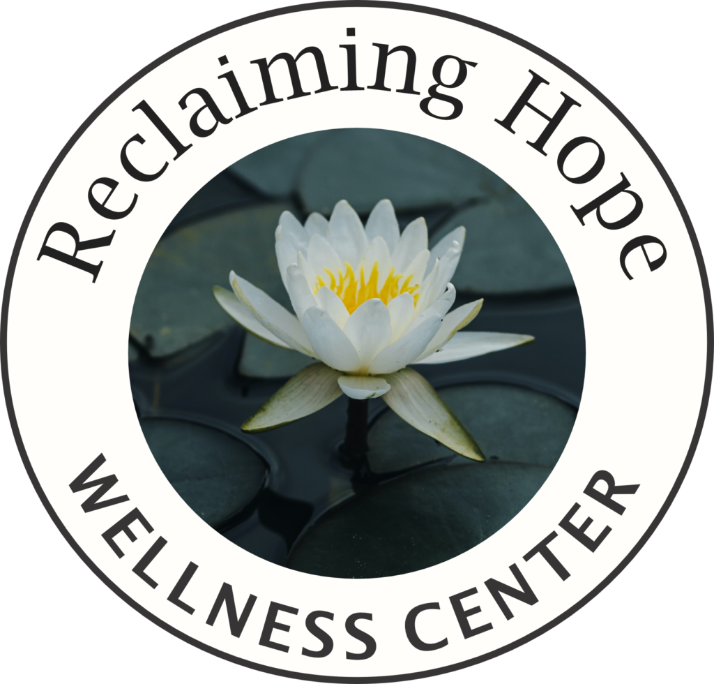 Reclaiming Hope Wellness Center round logo with a white lotus in the center